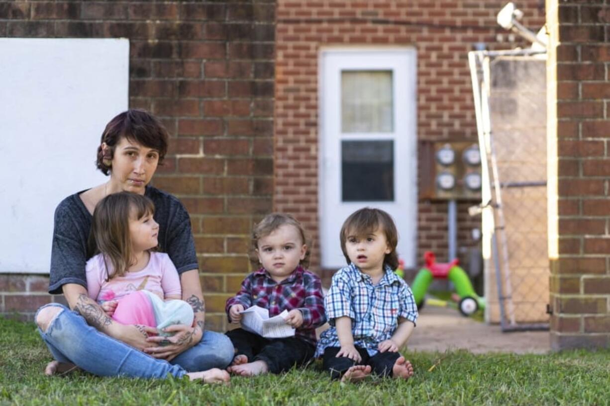 Kandise Norris, shown here with her three children in a Nov. 7 photo outside their home in Somerset County, Maryland, says she has been rebuilding her life since getting treatment for drug addiction in April 2019. The Housing Authority of Crisfield, Maryland, which owns her house, has filed three eviction cases against the 30-year-old since September.