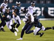 Seattle Seahawks&#039; DK Metcalf, left, is tackled by Philadelphia Eagles&#039; Darius Slay during the first half of an NFL football game, Monday, Nov. 30, 2020, in Philadelphia.