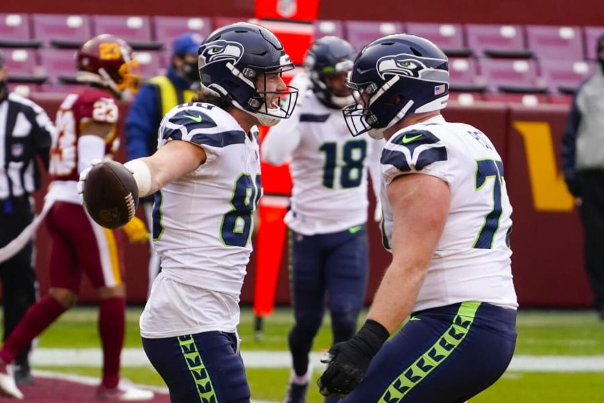 Seattle Seahawks tight end Jacob Hollister (86) celebrating his touchdown with teammate Seattle Seahawks center Ethan Pocic (77) during the first half of an NFL football game against the Washington Football Team, Sunday, Dec. 20, 2020, in Landover, Md.