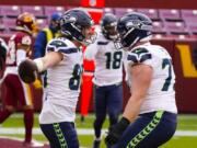 Seattle Seahawks tight end Jacob Hollister (86) celebrating his touchdown with teammate Seattle Seahawks center Ethan Pocic (77) during the first half of an NFL football game against the Washington Football Team, Sunday, Dec. 20, 2020, in Landover, Md.