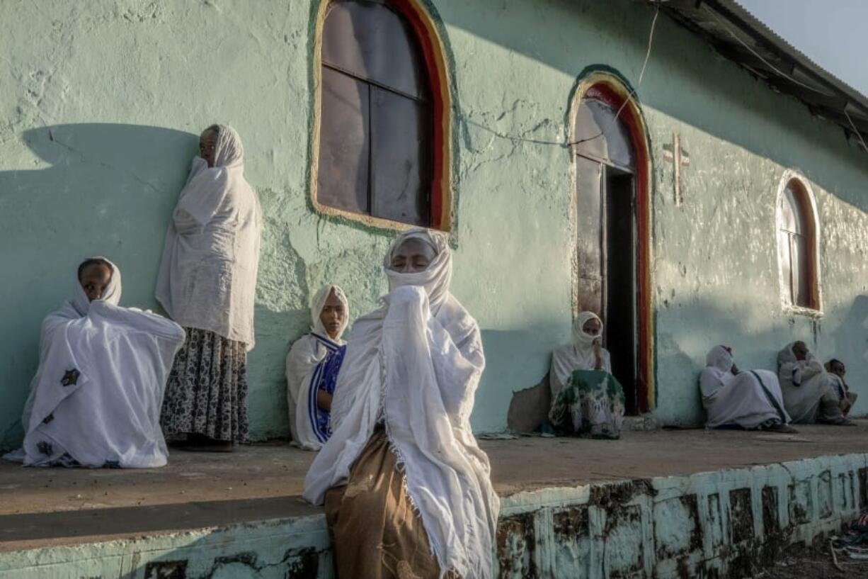 Tigrayan women who fled the conflict in Ethiopia&#039;s Tigray region, pray during Sunday Mass at a church, near Umm Rakouba refugee camp in Qadarif, eastern Sudan, Nov. 29, 2020.