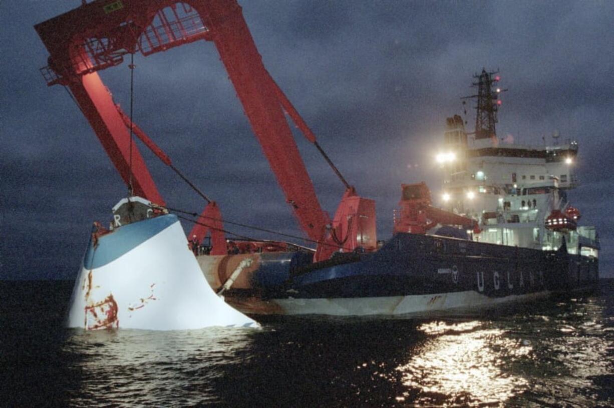 FILE - In this Nov. 19, 1994 file photo, the bow door of the sunken passenger ferry M/S Estonia is lifted up from the bottom of the sea, off Uto Island, in the Baltic Sea. Sweden&#039;s government wants divers to go down to the wreck of one of Europe&#039;s deadliest peacetime maritime disasters, the sinking of a ferry in the Baltic Sea in 1994 that killed 852 people, in order to check claims of a large hole in the hull. A 1997 report had concluded that the M/S Estonia -- that was sailing from Tallinn to Stockholm -- sank after the bow door locks failed in a storm, and flatly rejected the theory of a hole, which has long been the focus of speculate on about a possible explosion on board. Sweden&#039;s home affairs minister said on Friday, Dec. 18, 2020 that the government wants divers to investigate, but gave no timeline for an official dive.