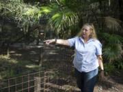 FILE - In this July 20, 2017, file photo, Carole Baskin, founder of Big Cat Rescue, walks the property near Tampa, Fla. Officials said, a female volunteer who regularly feeds big cats was bitten and seriously injured by a tiger Thursday morning, Dec.