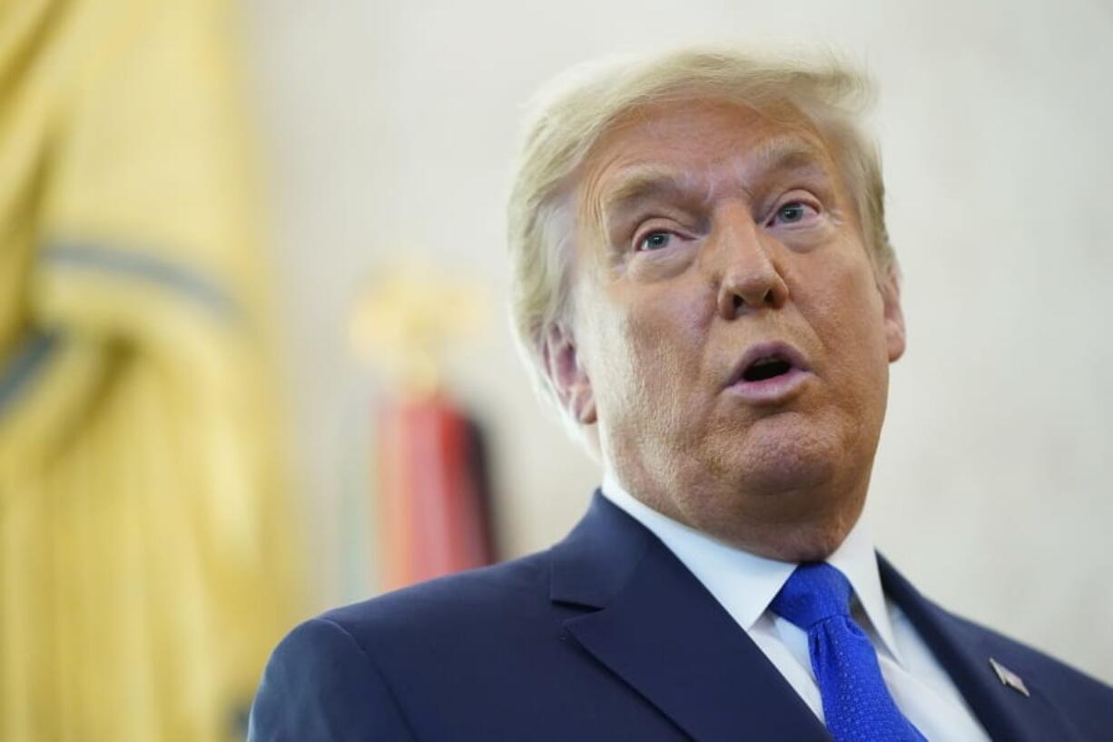 President Donald Trump speaks after awarding the Presidential Medal of Freedom, the highest civilian honor, to Olympic gold medalist and former University of Iowa wrestling coach Dan Gable in the Oval Office of the White House, Monday, Dec. 7, 2020, in Washington.