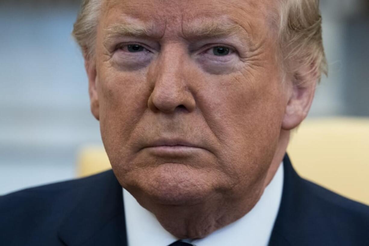 FILE - In this Jan. 27, 2020, file phoot President Donald Trump listens during a meeting with Israeli Prime Minister Benjamin Netanyahu in the Oval Office of the White House in Washington. The most improbable of presidents, Donald Trump reshaped the office and shattered its centuries-old norms and traditions while dominating the national discourse like no one before.