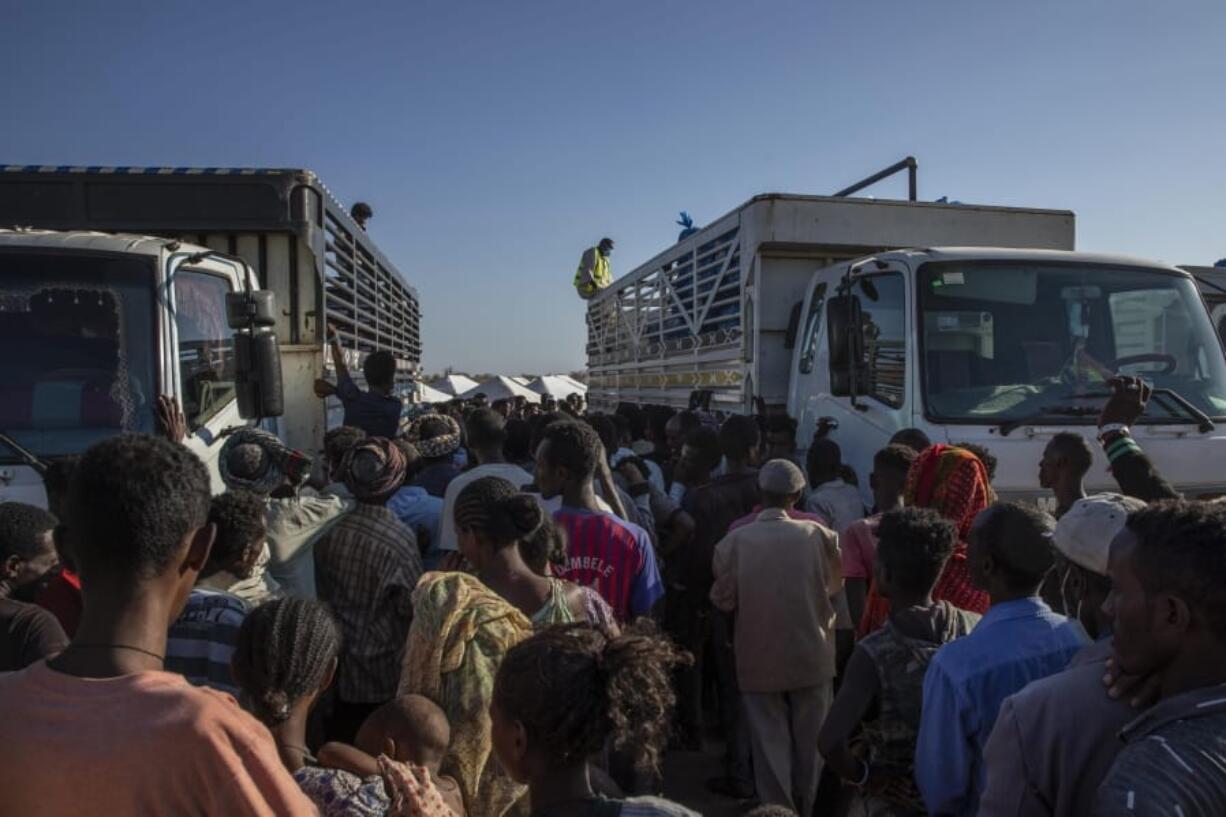 FILE - In this Tuesday, Nov. 24, 2020 file photo, Tigray refugees who fled the conflict in Ethiopia&#039;s Tigray region, wait to receive aid at Umm Rakouba refugee camp in Qadarif, eastern Sudan. A key U.N.