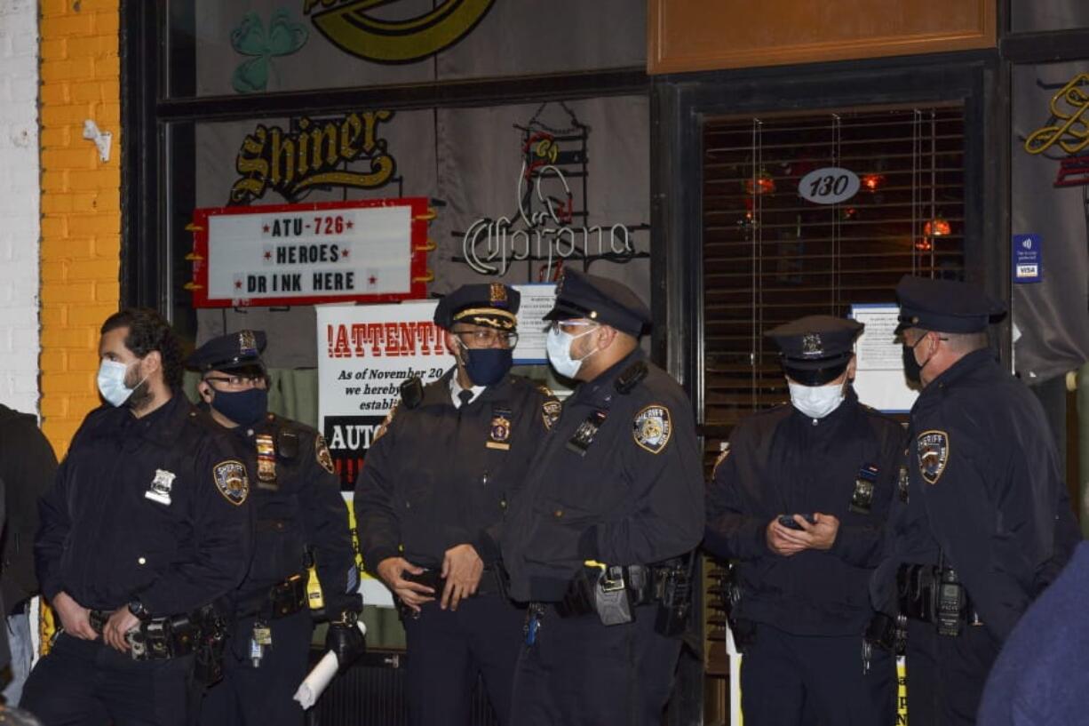 FILE --In this Dec. 1, 2020 file photo, New York City Sheriff&#039;s deputies stand outside Mac&#039;s Public House after co-owner Danny Presti was arrested, in the Staten Island borough of New York.  A crackdown on COVID-19 restriction violators has drawn attention to a sheriff in New York City few knew existed. Sheriff Joseph Fucito has worn the badge for the past six years in a civil-enforcement post that hasn&#039;t carried the notoriety of his counterparts with roots in Wild West folklore.