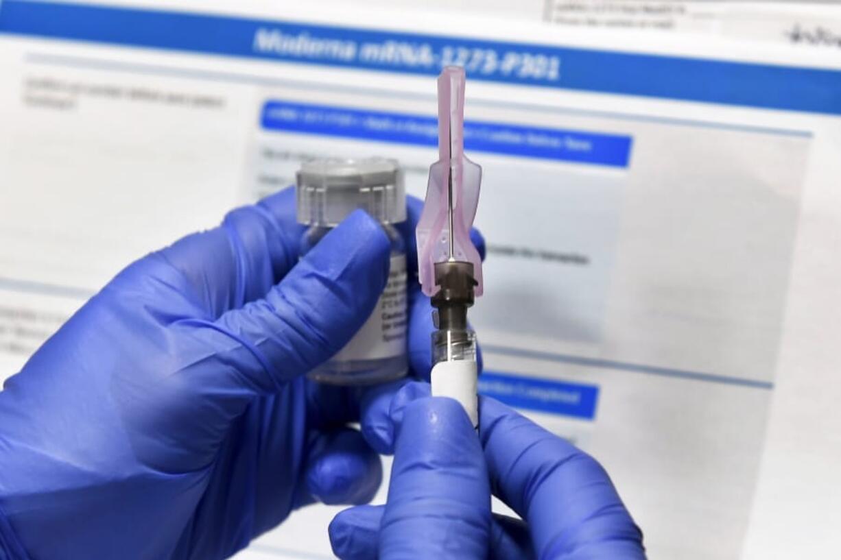 FILE - In this Monday, July 27, 2020 file photo, a nurse prepares a syringe during a study of a possible COVID-19 vaccine, developed by the National Institutes of Health and Moderna Inc., in Binghamton, N.Y. With coronavirus vaccines on the horizon, when and where will most Americans get their shots? Many of the details are still being worked out, as regulators review the first vaccine candidates. A federal panel of vaccine experts is meeting this week to consider Pfizer&#039;s vaccine, and again next week for Moderna&#039;s.