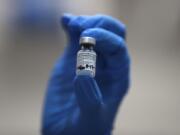 A nurse holds a phial of the Pfizer-BioNTech COVID-19 vaccine at Guy&#039;s Hospital in London, Tuesday, Dec. 8, 2020. U.K. health authorities rolled out the first doses of a widely tested and independently reviewed COVID-19 vaccine Tuesday, starting a global immunization program that is expected to gain momentum as more serums win approval.