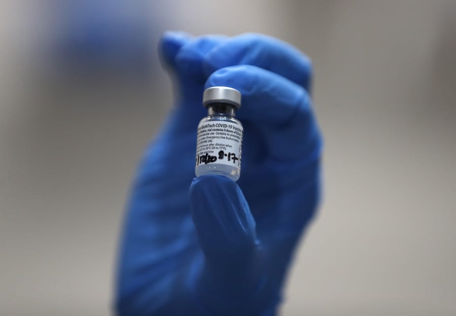 A nurse holds a phial of the Pfizer-BioNTech COVID-19 vaccine at Guy&#039;s Hospital in London, Tuesday, Dec. 8, 2020. U.K. health authorities rolled out the first doses of a widely tested and independently reviewed COVID-19 vaccine Tuesday, starting a global immunization program that is expected to gain momentum as more serums win approval.