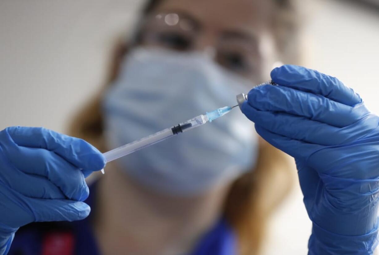 A nurse prepares a shot of the Pfizer-BioNTech COVID-19 vaccine at Guy&#039;s Hospital in London, Tuesday, Dec. 8, 2020, as the U.K. health authorities rolled out a national mass vaccination program.  U.K. regulators said Wednesday Dec. 9, 2020, that people who have a &quot;significant history&#039;&#039; of allergic reactions shouldn&#039;t receive the new Pfizer/BioNTech vaccine while they investigate two adverse reactions that occurred on the first day of the country&#039;s mass vaccination program.