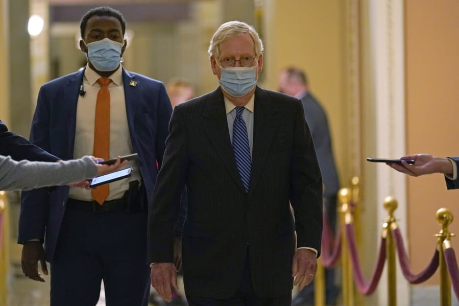 In this Dec. 15, 2029, photo, Senate Majority Leader Mitch McConnell of Ky., walks past reporters on Capitol Hill in Washington.