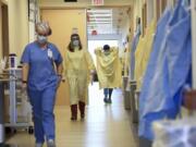 Nurses and medical staff make their way through the seventh floor COVID-19 unit at East Alabama Medical Center Thursday, Dec. 10, 2020, in Opelika, Ala. COVID-19 patients occupy most of the beds in ICU in addition to the non-critical patients on the seventh floor.