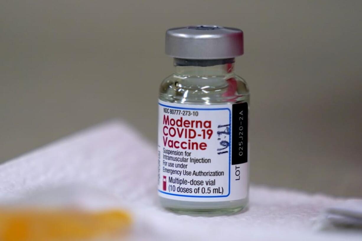 A bottle of Moderna&#039;s COVID-19 vaccine is seen   Wednesday. Portland-area first responders began receiving their vaccinations this week.