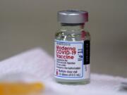 A bottle of Moderna&#039;s COVID-19 vaccine is seen   Wednesday. Portland-area first responders began receiving their vaccinations this week.