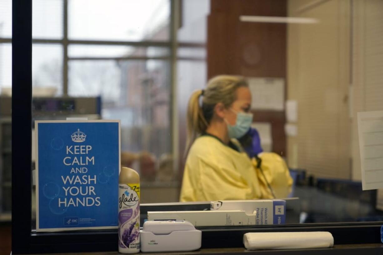 FILE - In this Nov. 24, 2020, file photo, registered nurse Chrissie Burkhiser works in the emergency room at Scotland County Hospital in Memphis, Mo. Scientists say there is reason for concern but not alarm about new strains of the coronavirus, especially the one currently spreading in England.