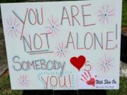 In this Oct. 2020 photo provided by Debra Ferrell, a sign with encouraging words stands in a neighbor&#039;s yard in Roanoke, Va., after Ferrell placed it there. For her 53rd birthday this year, Ferrell decided to give back with 53 acts of kindness, big and small, for people across the country.