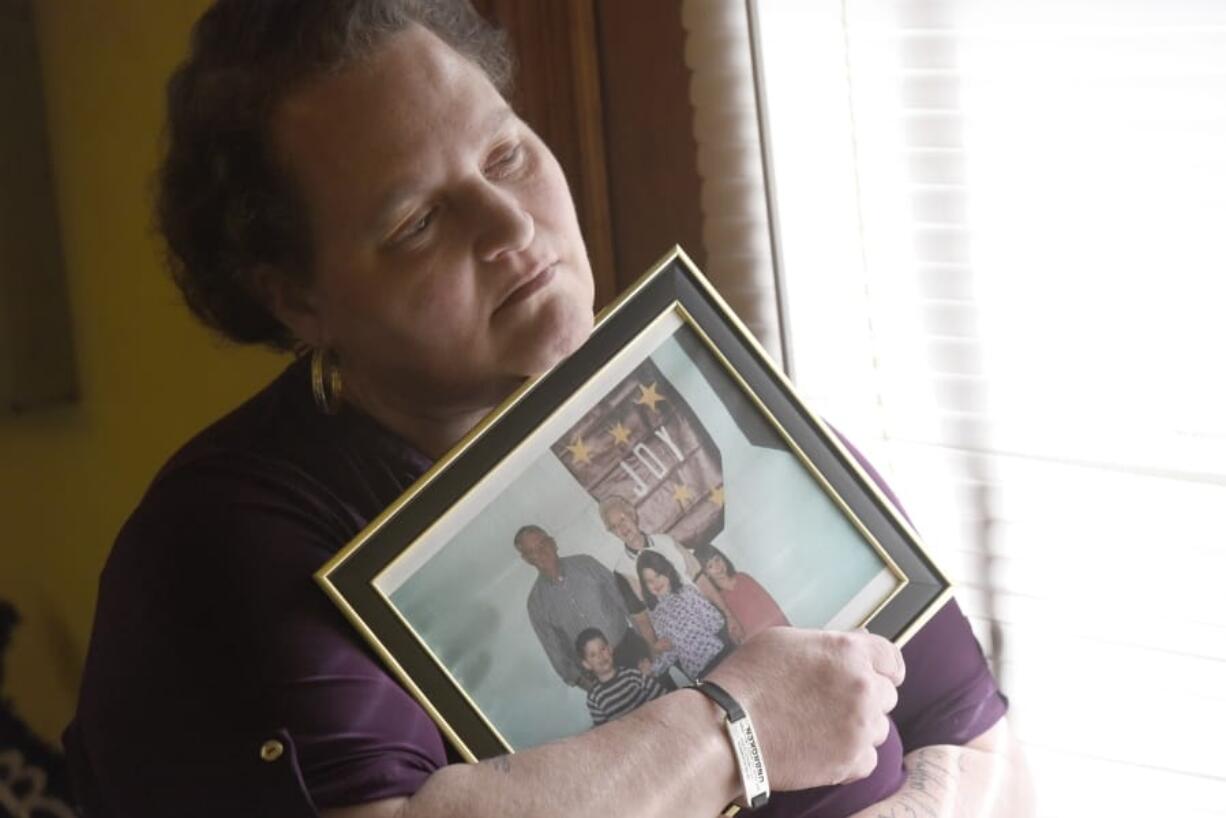 Christina Grim holds a family photograph that includes her mother, Verl Grim, top right, on Saturday, Dec. 19, 2020, at her home in Littlestown, Pa. Grim contends that an H1N1 vaccination triggered her mother&#039;s Guillain-Barre syndrome, an immune system disorder that caused her death in 2010. But she missed a one-year deadline for filing and her claim to the federal Countermeasures Injury Compensation Program was denied.