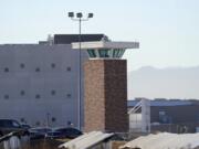 The guard tower stands near the Colorado Department of Corrections Denver Reception and Diagnostic Center Tuesday, Dec. 8, 2020, in east Denver. Amber Johnson of Fayetteville, Ark., is fighting for vaccination against the coronavirus for her 63-year-old father, Ronald, who is an inmate in the prison.