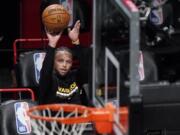 Golden State Warriors guard Stephen Curry shoots as players warm up for the team&#039;s NBA basketball game against the Brooklyn Nets, Tuesday, Dec. 22, 2020, in New York.