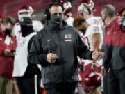 Washington State head coach Nick Rolovich walks the sideline during the second half of an NCAA college football game against Southern California in Los Angeles, Sunday, Dec. 6, 2020.