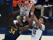 West Virginia&#039;s Oscar Tshiebwe (34) and Gonzaga&#039;s Anton Watson (22) vie for a rebound during the first half of an NCAA college basketball game Wednesday, Dec. 2, 2020, in Indianapolis.