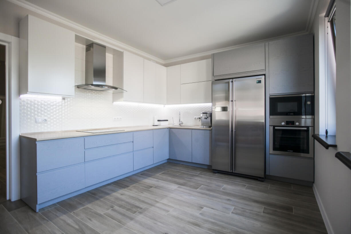 Repainting cabinets can update a kitchen without remodeling it.