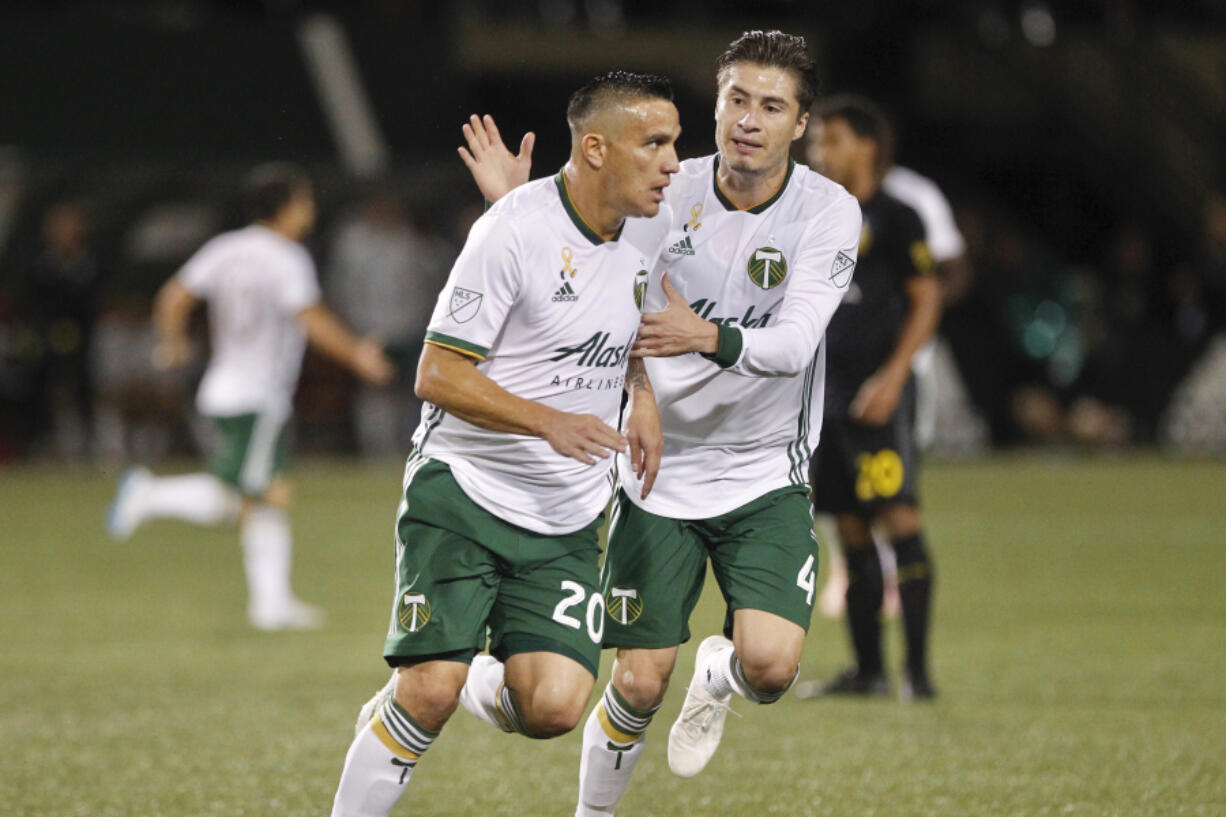 Portland Timbers&#039; David Guzman (20) celebrates his first-half goal against the Columbus Crew during a Major League Soccer match Wednesday, Sept. 19, 2018, in Portland, Ore. At right is Portland&#039;s Jorge Villafana.