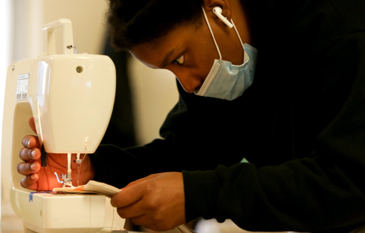 Jay Nixon uses a sewing machine at City Sewing Room in St. Louis on Wednesday, Dec. 23, 2020. Nixon recently learned how to sew and is making a jacket for herself. City Sewing Room offers sewing lessons to both beginners and those with experience. The business also offers a monthly membership that includes a work table and storage space. (Christine Tannous/St. Louis Post-Dispatch/TNS) (Christine Tannous/St.