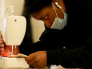 Jay Nixon uses a sewing machine at City Sewing Room in St. Louis on Wednesday, Dec. 23, 2020. Nixon recently learned how to sew and is making a jacket for herself. City Sewing Room offers sewing lessons to both beginners and those with experience. The business also offers a monthly membership that includes a work table and storage space. (Christine Tannous/St. Louis Post-Dispatch/TNS) (Christine Tannous/St.