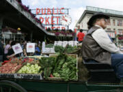 A horse drawn produce wagon driven by Wayne Buckner, of Falls City, sits in 2007 at the Pike Place Market in Seattle.