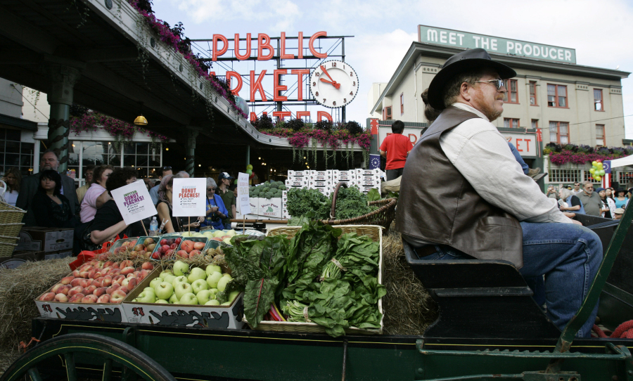 A horse drawn produce wagon driven by Wayne Buckner, of Falls City, sits in 2007 at the Pike Place Market in Seattle.