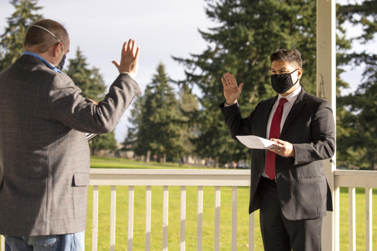 Retiring state Court of Appeals Judge Rich Melnick, left, swears in incoming Judge Bernard Veljacic on Dec. 31 at the bandstand at Fort Vancouver National Historic Site.