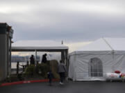 Customers make their way into a dining tent along the exterior of Beaches Restaurant &amp; Bar on Thursday. Indoor dining has been banned in Washington since November due to a spike in COVID-19 cases.