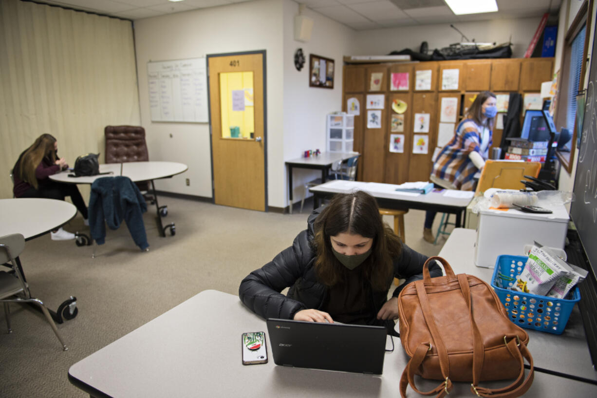 Freshman Jaydyn Clark, 14, from left, joins fellow student Adelita Spears-Diaz and teacher Stacey Oman as they do classwork in person at Legacy High School. Local school districts have welcomed students deemed academically at-risk for in-person assistance in remote learning. Legacy has 15 to 20 students daily working in small groups at the school since September. Spears-Diaz, a sophomore, said she prefers working at school than home for remote learning.