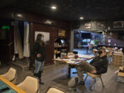 Katie O&#039;Daniel, left, of Skip the Trip delivery chats with Ben Jackson, owner of Washougal Times, at his restaurant on Thursday. Skip the Trip delivers food from restaurants to doorsteps. At top, Skip the Trip employs independent-contract drivers who are screened and wear uniforms.