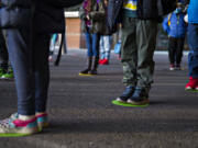 Kindergartners and first-graders at Crestline Elementary School line up on their spot while social distancing before class.