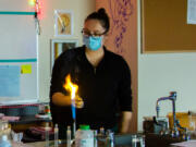 WOODLAND: Stephanie Marshall, a high school science teacher, lights magnesium on fire to demonstrate chemical reactions during a recent virtual science lab.