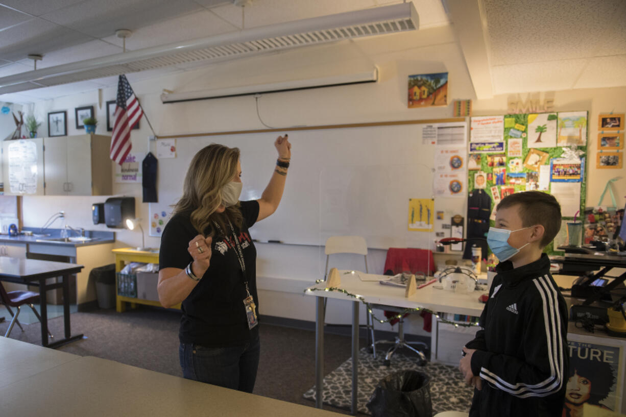 Humanities teacher Chrissie Woodruff, left, shows her enthusiasm for the return of students to the classroom while greeting sixth grader Tucker Troffer, 11, during a school tour at Liberty Middle School this week. Camas&#039; middle schools are gearing up to welcome sixth graders in small-group settings for the first time.