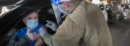 Chuck Adams of La Center, left, gives a thumbs-up while receiving his COVID-19 vaccination from Staff Sgt. Cory Hoveskeland of the National Guard at the Clark County Event Center at the Fairgrounds on Tuesday morning, January 26, 2021. Adams said getting the vaccination went smoothly. "I didn't even feel it," he said. Tuesday was the first day of mass vaccinations in Clark County, which are given by appointment only.