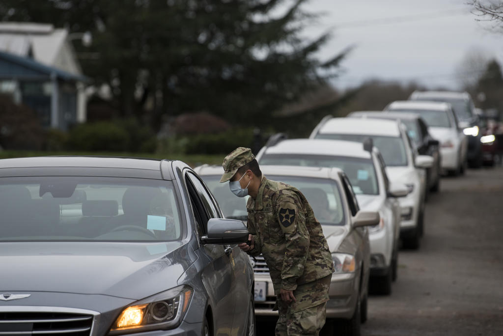 Israel De La Cruz of the National Guard helps direct motorists as they prepare to get their COVID-19 vaccine at the Clark County Event Center at the Fairgrounds on Tuesday morning, January 26, 2021.