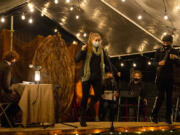 Parielle Shapard as the old green grasshopper, center, and Nick Campos as the centipede perform during Friday night&#039;s staged reading of &quot;James and the Giant Peach,&quot; by Downstage Center Productions, at The Historic Academy in downtown Vancouver. That&#039;s a giant peach pit behind them, of course.