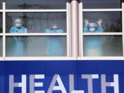 Swedish Medical Center health care workers battling the coronavirus outbreak look on from inside the hospital as first responders gathered outside in support of them in Seattle in April. The COVID-19 pandemic was Washington state's top story for 2020.