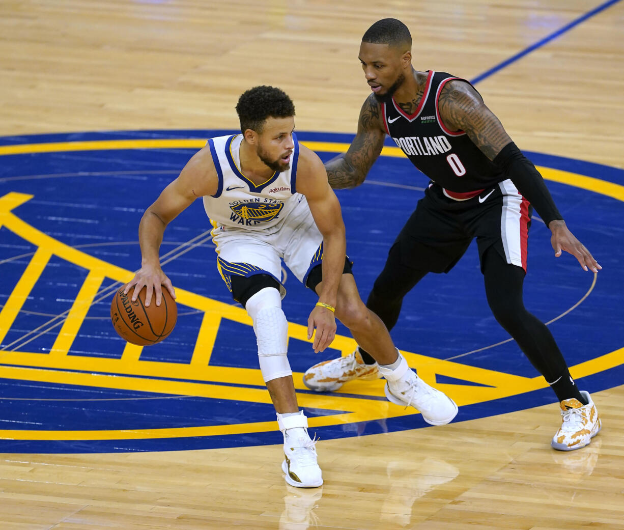 Golden State Warriors guard Stephen Curry (30) dribbles past Portland Trail Blazers guard Damian Lillard (0) during the second half of an NBA basketball game in San Francisco, Friday, Jan. 1, 2021. Portland won 123-98.