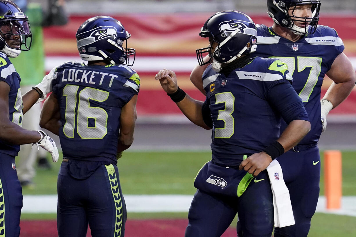 Seattle Seahawks wide receiver Tyler Lockett (16) celebrates his touchdown with quarterback Russell Wilson (3) during the second half of an NFL football game against the San Francisco 49ers, Sunday, Jan. 3, 2021, in Glendale, Ariz. (AP Photo/Ross D.