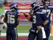 Seattle Seahawks wide receiver Tyler Lockett (16) celebrates his touchdown with quarterback Russell Wilson (3) during the second half of an NFL football game against the San Francisco 49ers, Sunday, Jan. 3, 2021, in Glendale, Ariz. (AP Photo/Ross D.