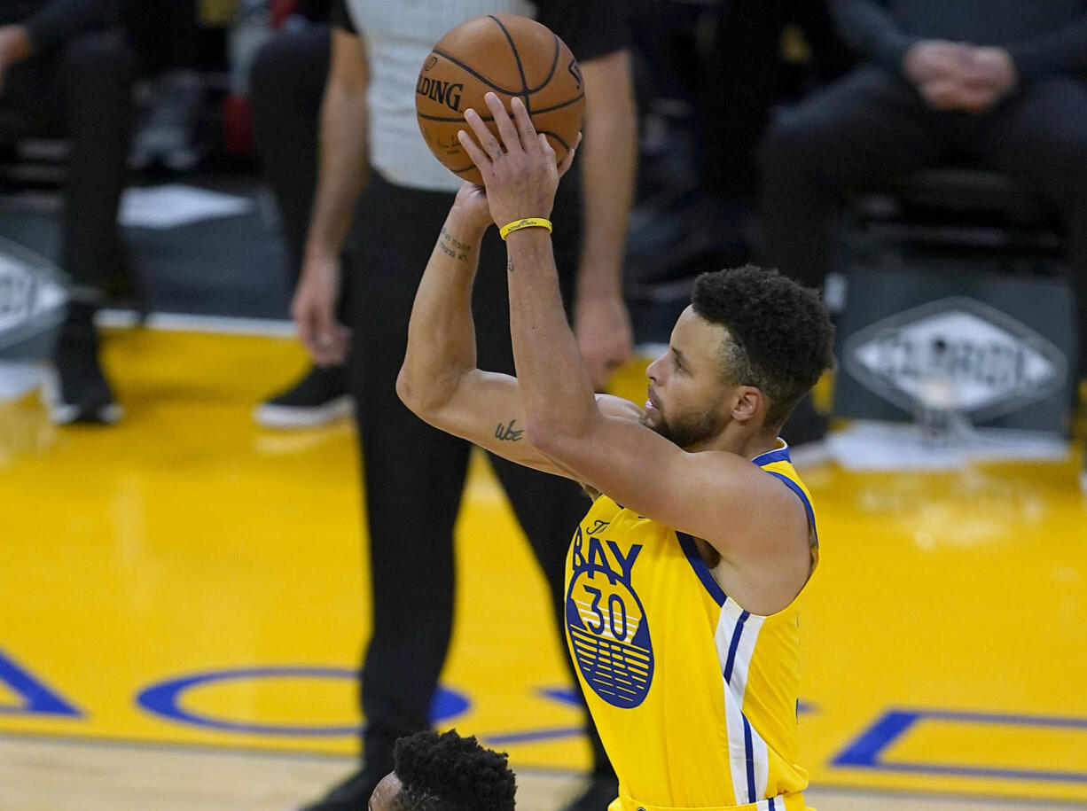 Golden State Warriors guard Stephen Curry (30) takes a three-point shot over Portland Trail Blazers guard CJ McCollum (3) during the first half of an NBA basketball game in San Francisco, Sunday, Jan. 3, 2021.