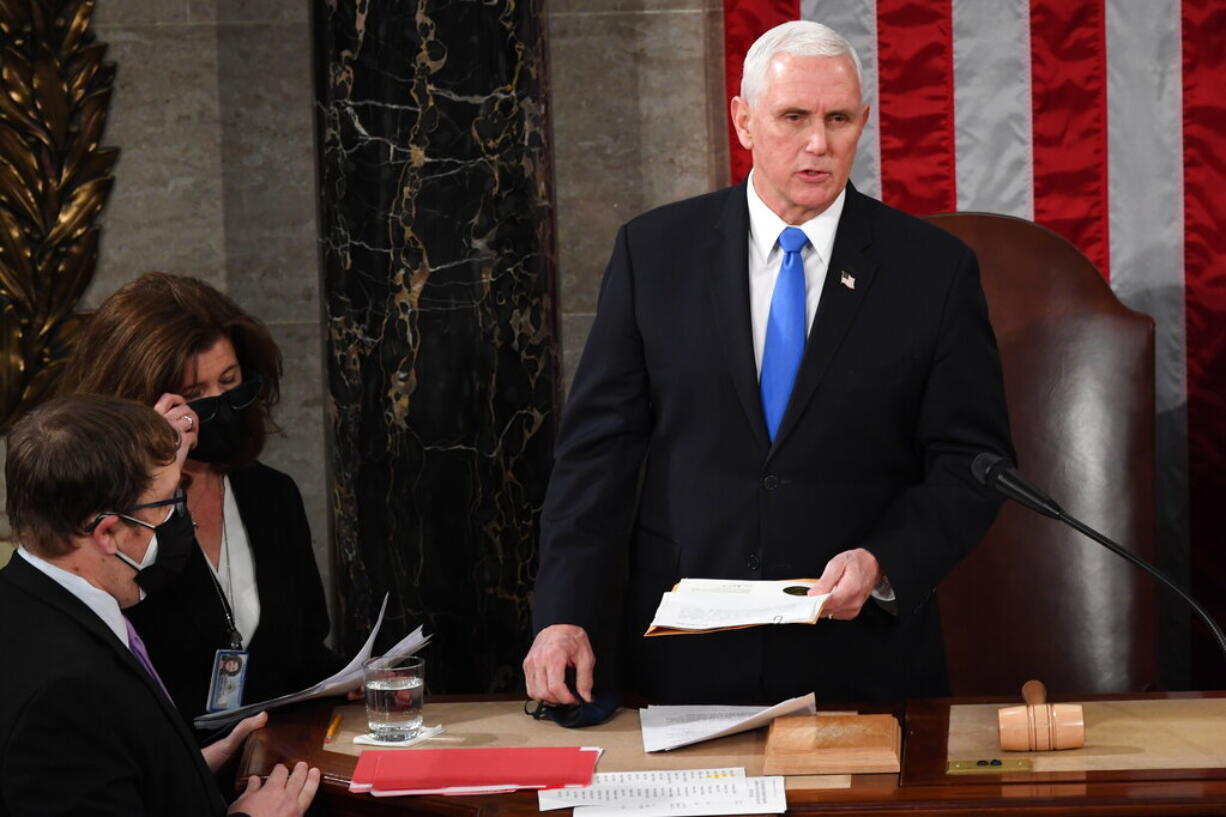 Vice President Mike Pence presides over a joint session of Congress as it convenes to count the Electoral College votes cast in November's election, at the Capitol in Washington, Wednesday, Jan. 6, 2021.