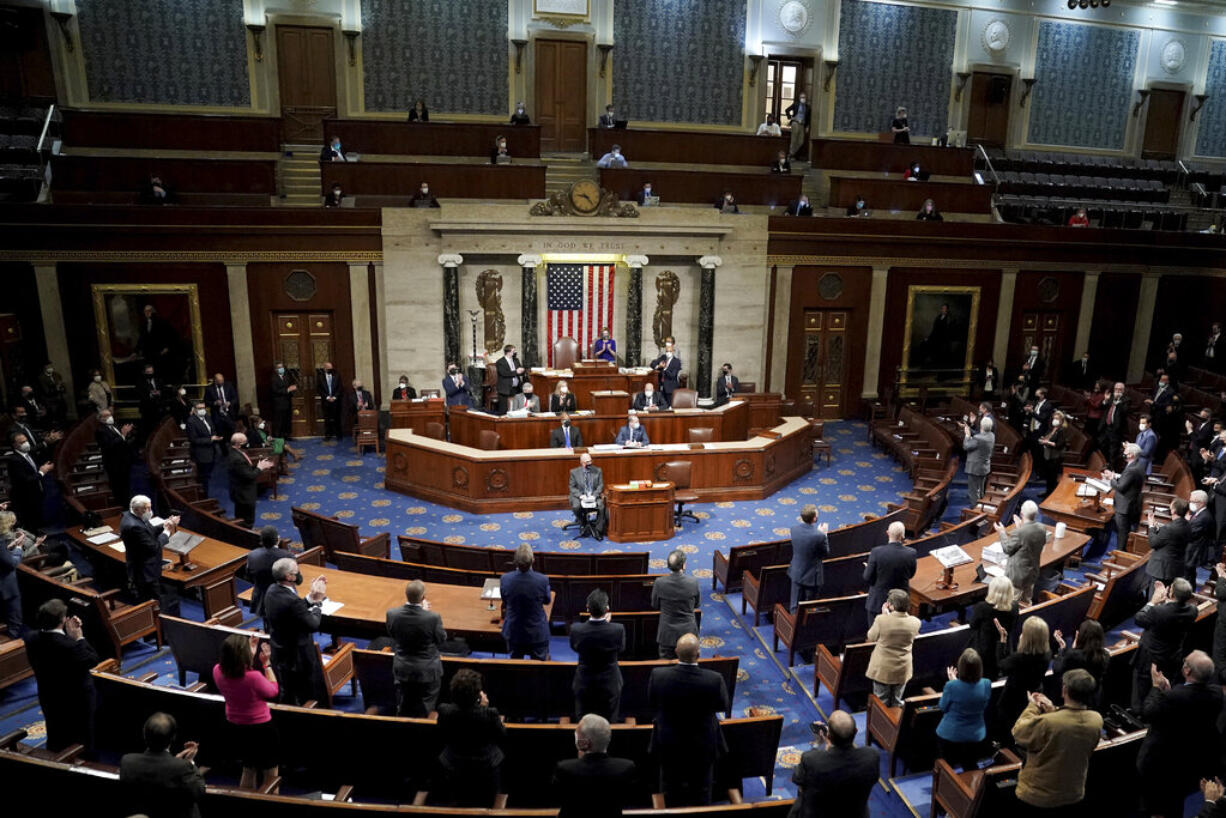 Members of the House listen in the House Chamber after they reconvened for arguments over the objection of certifying Arizona’s Electoral College votes in November’s election, at the Capitol in Washington, Wednesday, Jan. 6, 2021.