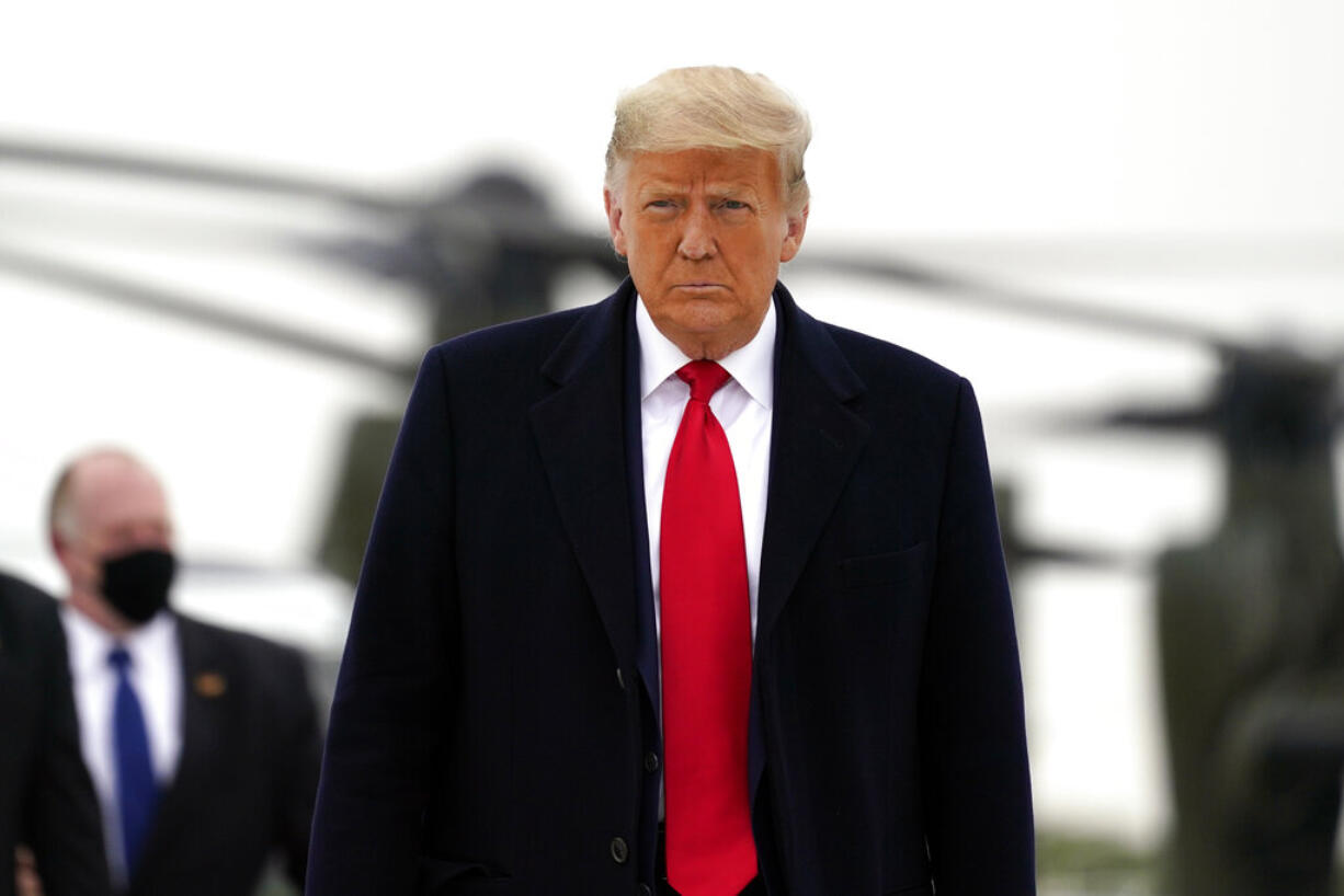 President Donald Trump boards Air Force One upon arrival at Valley International Airport, Tuesday, Jan. 12, 2021, in Harlingen, Texas, after visiting a section of the border wall with Mexico in Alamo, Texas.